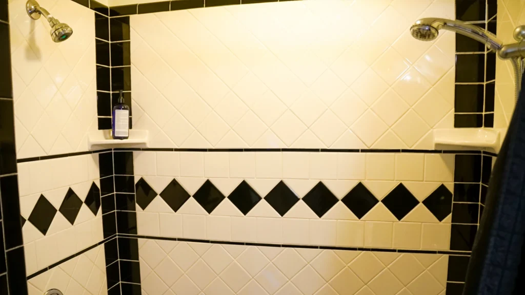 Black and cream tile shower after professional bathroom tile refinishing